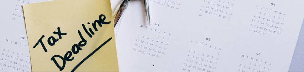 hybrid car tax - a yellow sticky note reading 'tax deadline' stuck on a calendar