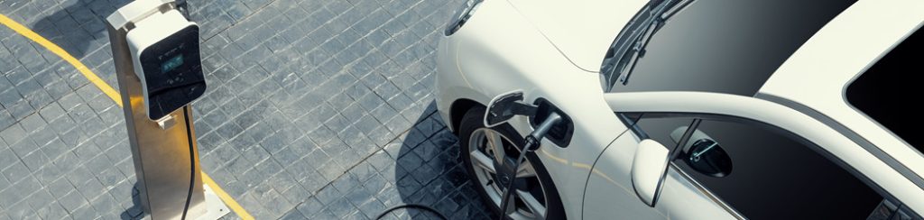 an electric car bought using an EV company car scheme is plugged into an EV charger