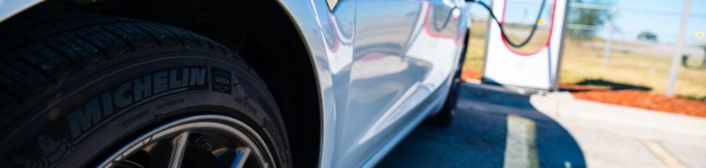 close up of EV tyres whilst the car is on charge